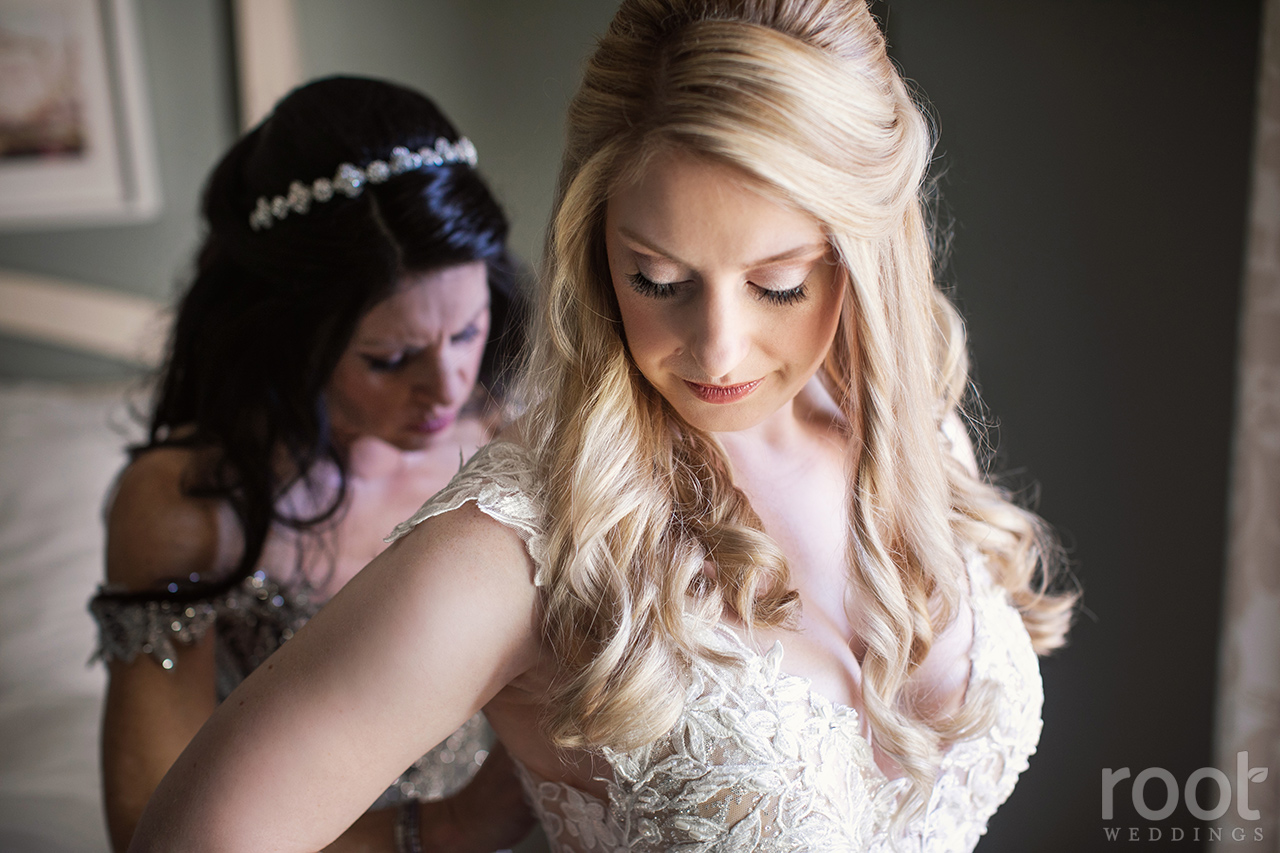 Mother of the bride dressing her daughter