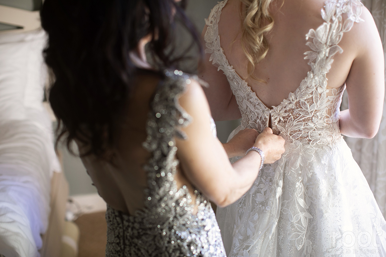 Mother of the bride dressing her daughter