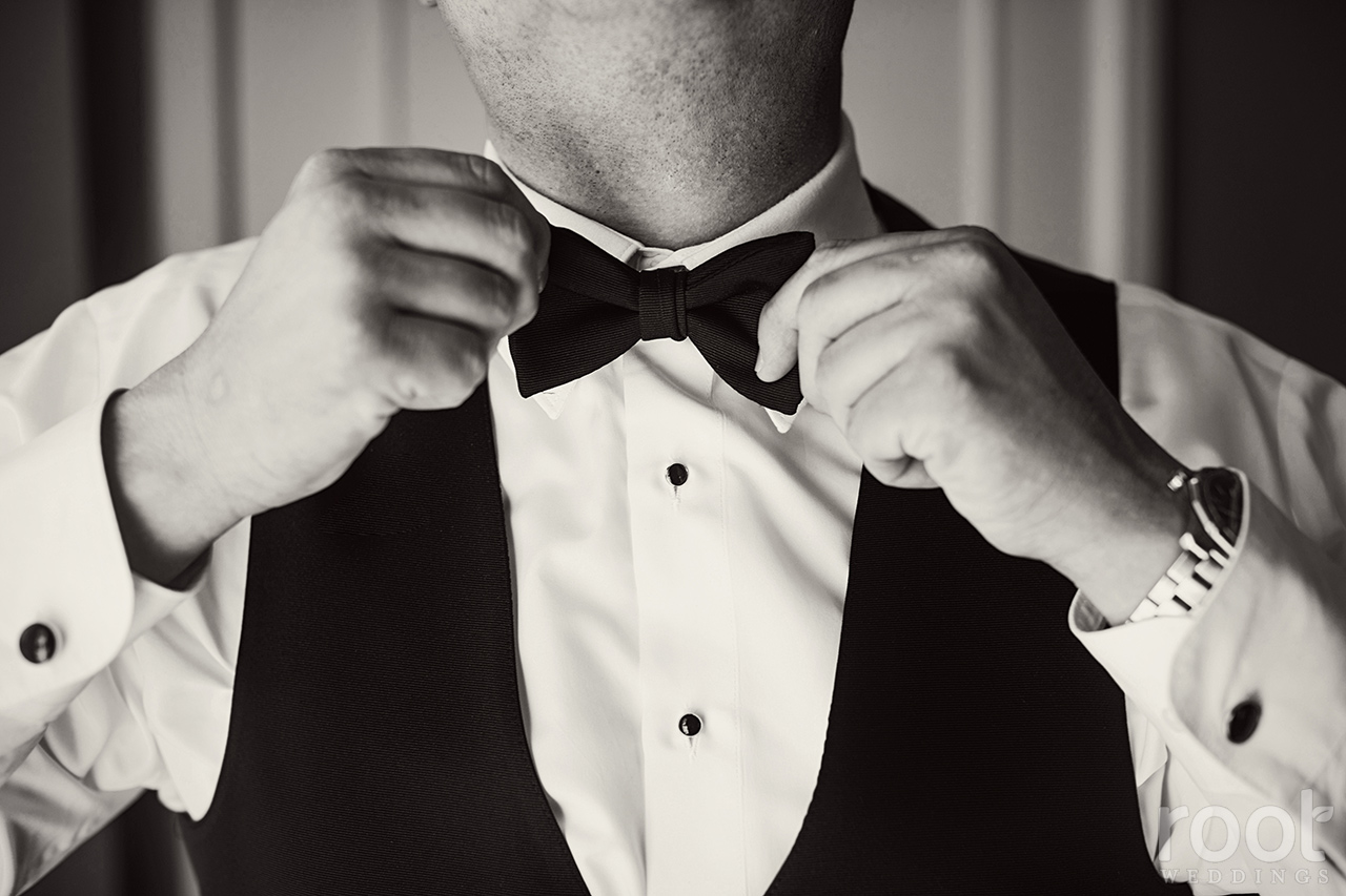 Groom straightening his bowtie